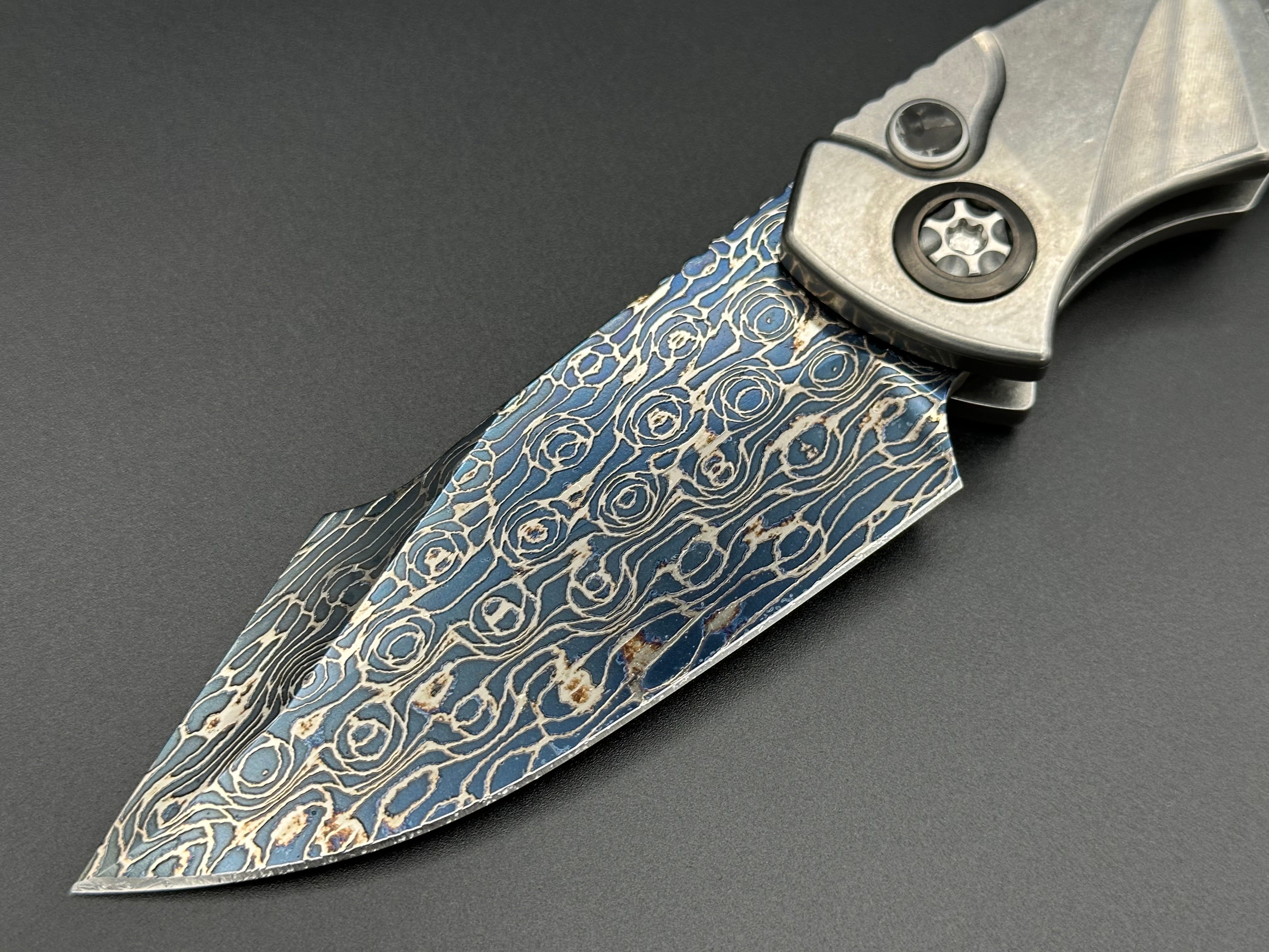 Heretic Knives Pariah Auto Titanium and Baker Forge Silver Snakeskin Inlay w/ Blued VF Damascus SE - Tristar Edge