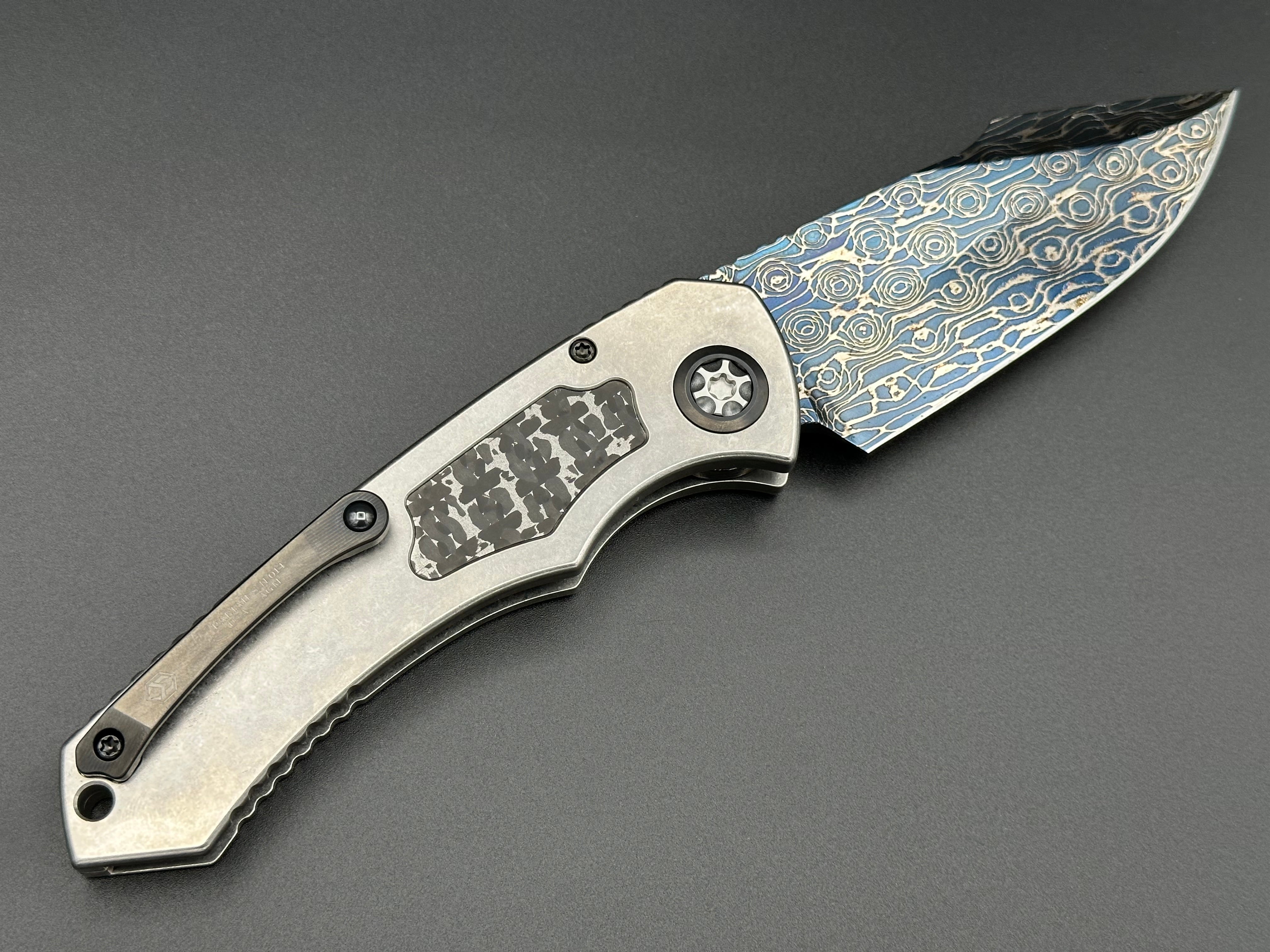 Heretic Knives Pariah Auto Titanium and Baker Forge Silver Snakeskin Inlay w/ Blued VF Damascus SE - Tristar Edge